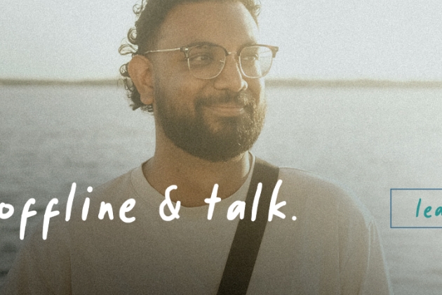 Get Offline and Talk campaign banner, featuring two men having a conversation in front of the ocean